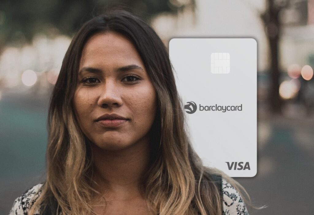 A close-up portrait of a woman with a calm expression, standing outdoors with the Barclaycard Platinum Balance Transfer No Fee Card visible beside her.