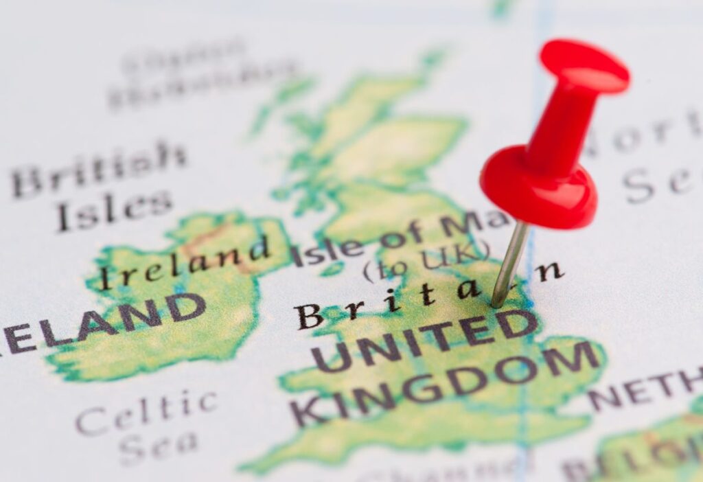 A red pin marking the United Kingdom on a map, highlighting the UK and Ireland regions.