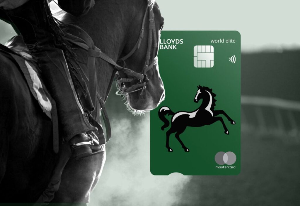 A close-up of a black horse in elegant gear, exuding power and sophistication, paired with the Lloyds Bank World Elite Mastercard against a soft green background.