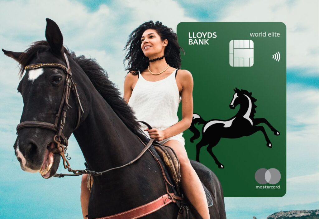 A woman confidently riding a black horse in an open field, symbolising freedom and prestige, with the Lloyds Bank World Elite Mastercard prominently displayed next to her.