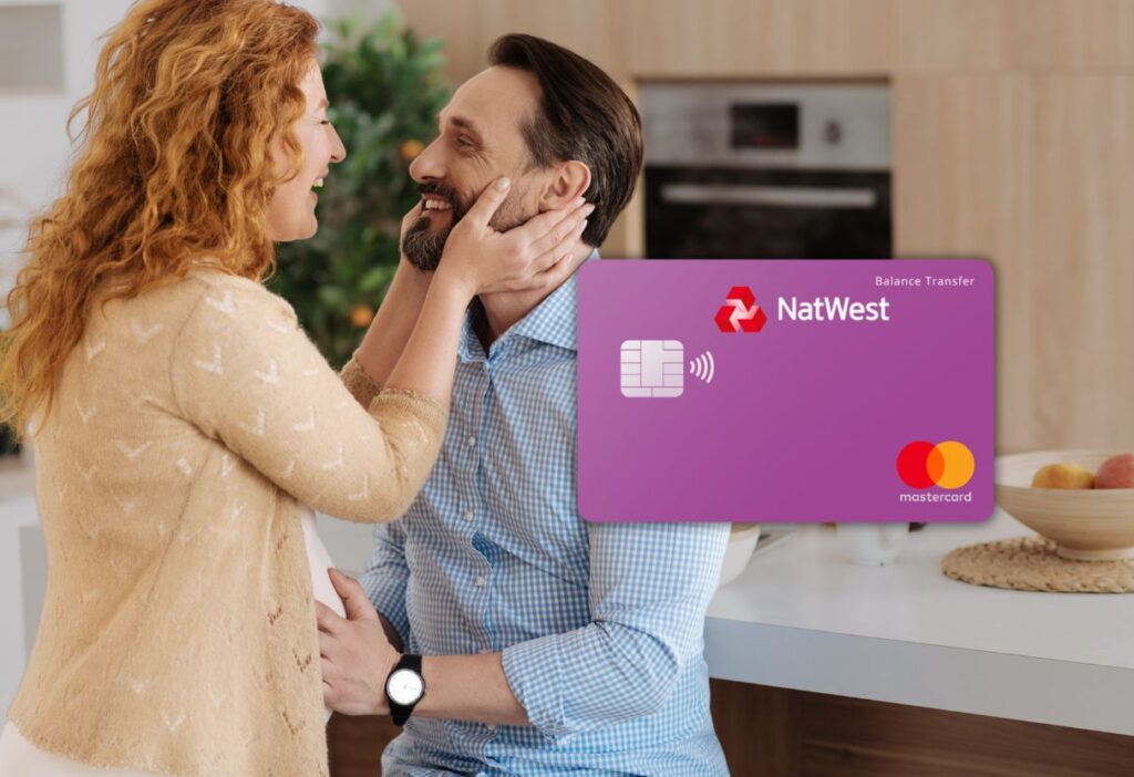 Smiling couple sharing a tender moment in a cosy kitchen with a purple NatWest balance transfer credit card overlay, representing financial stability and support for loved ones.