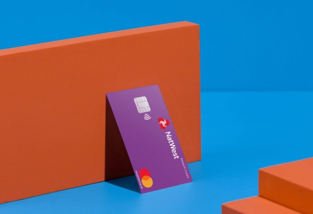 NatWest Reward Credit Card displayed against a bold orange and blue backdrop, showcasing its sleek design and practicality.