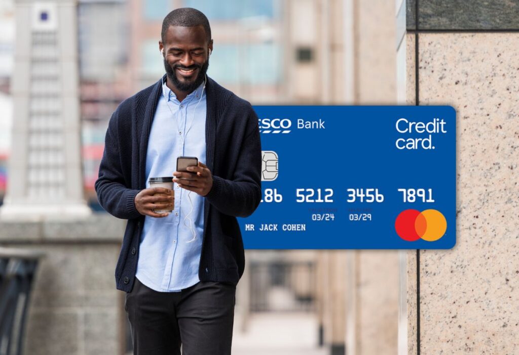 A smiling man on-the-go with the Tesco Bank Credit Card, offering flexible spending and secure management for everyday finances.