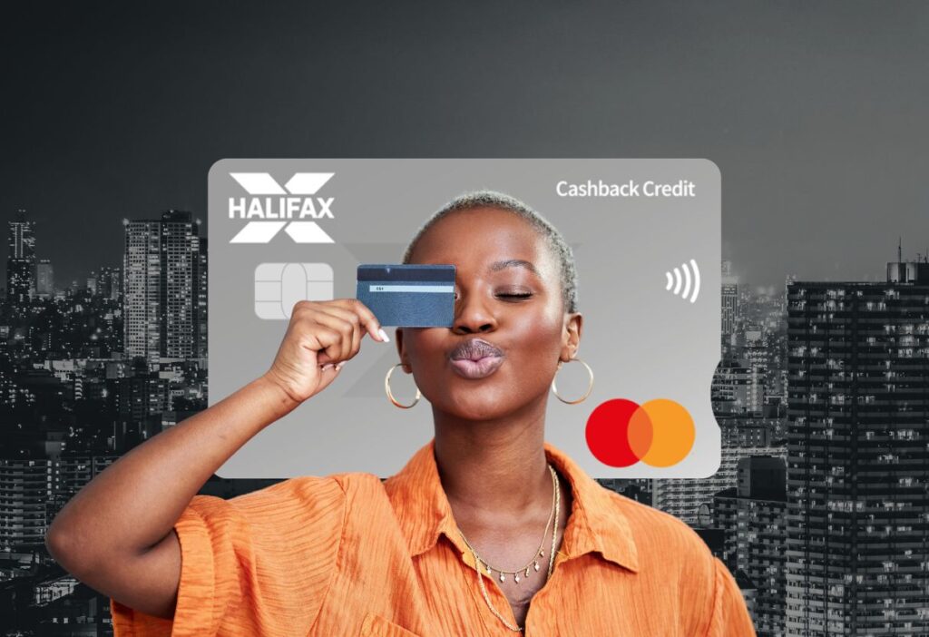 Confident woman playfully holding a card in front of her face, with the Halifax Cashback Credit Card in the background, symbolising smart spending and rewards.